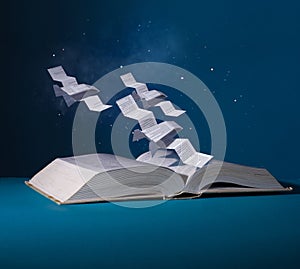 Space fighters are created from pages. Spaceships fly over an open book