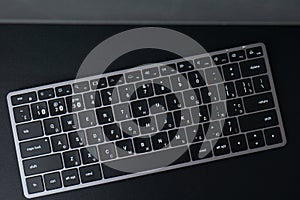 Space gray keyboard on a black background. bluetooth keyboard with english and russian layout