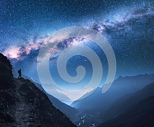 Space with Milky Way, girl and mountains at night photo