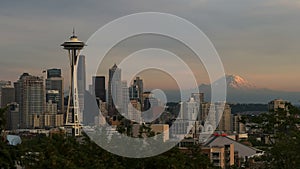 The space needle and mount rainier in seattle at sunset