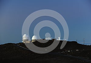 Space observatories at sunrise on top of Haleakala crater on Maui.