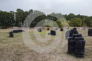 Space for playing paintball with the paint marks after fights. Abandoned paintball playground with barricades made of old tires
