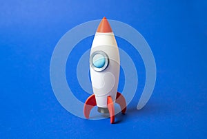 Space rocket on blue background. Concept of space aerotechnics. Advertising, startups