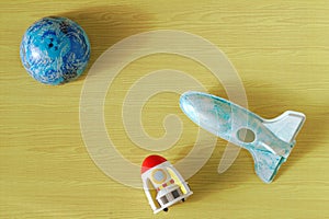 Space rocket toys Planet plastic modeling plane on yellow background