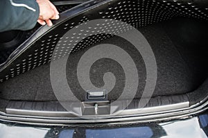 Space for spare tire under the boot mat of the car