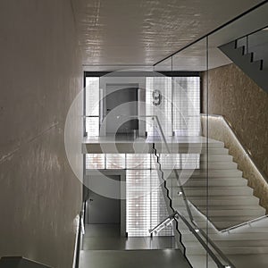 Space with stairs in an old but renovated building with large windows