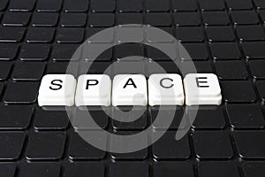 Space title text word crossword. Alphabet letter blocks game texture background. White alphabetical letters on black