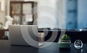 A space to get productive. Still life shot of a laptop on a table in an office.