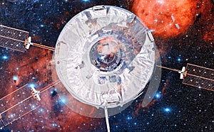 Spaceship in outer space against the background of the nebula.