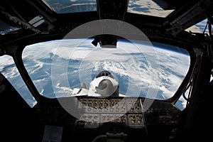 spaceshuttle launch, with view of the earth visible through the window