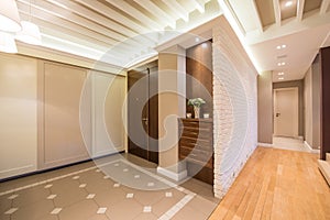 Spacious anteroom interior in warm tones and modern ceiling lights