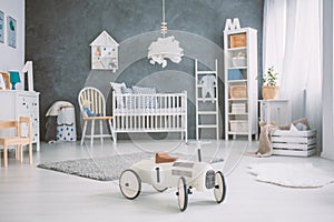 Spacious baby room with cot