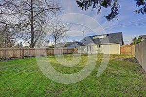 Spacious backyard with wooden fence and fire pit