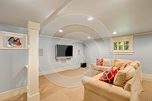 Spacious basement living room interior in pastel blue tones