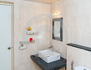 Spacious bathroom with rectangular sink and mirror; interior in light tones