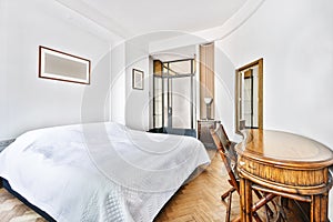 Spacious bedroom with bed and wooden table