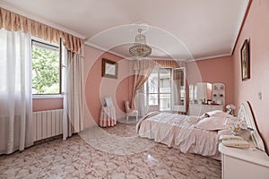 A spacious bedroom with a garish pink