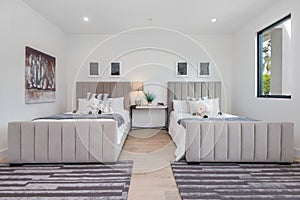 Spacious bedroom with two double beds in a modern new construction home in Los Angeles