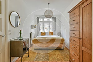 Spacious bright bedroom with a vintage bedside table and wardrobe