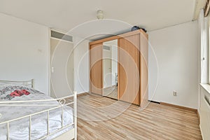 Spacious bright bedroom with a wardrobe with mirror