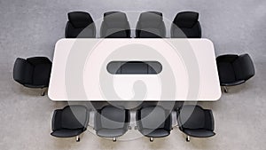 spacious conference table is centrally placed in a minimalist office with black chairs arranged around it. This setup is ideal for photo