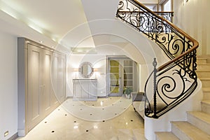 Spacious corridor with stylish staircase