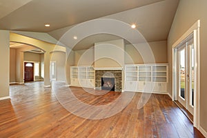 Spacious empty living room interior with vaulted ceiling