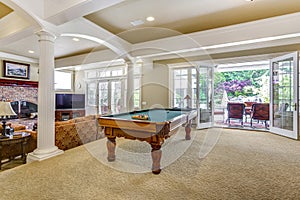 Light brown game room with billiard table