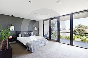 Spacious interior of designer master bedroom in luxury Australia