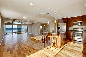 Spacious kitchen interior with hardwood floor and beige walls