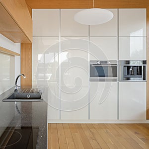 Spacious kitchen with white cupboards