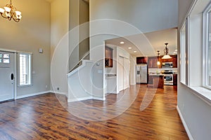 Spacious living room with high vaulted ceiling connected to kitchen