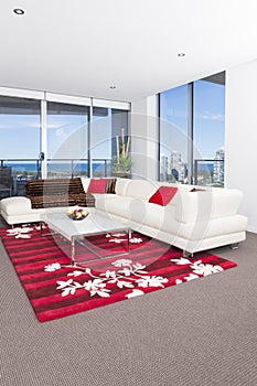 Spacious living room with a red carpet