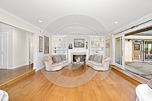 Spacious living room with sofas and fireplace in Encino, CA