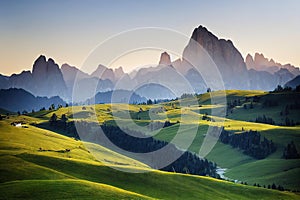 Spacious meadow with grass and the silhouette of mountains in the distance