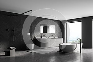 Spacious modern bathroom design interior in gray tones with concrete floor, freestanding tub, walk-in shower, double sink vanity.