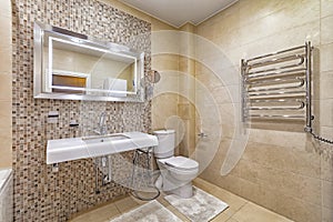 Spacious neat bathroom  in beige tile