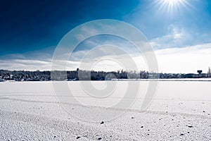 Spacious snow landscape. River and hills in Russia, white winter on the terrain, a lot of fluffy snow and ice under a beautiful bl