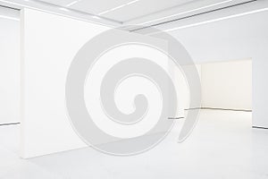 Spacious white gallery interior with empty exhibition stand
