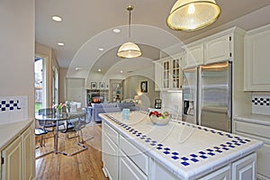 Spacious white kitchen interior with kitchen island.