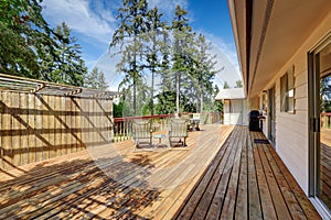 Spacious wooden deck with patio table set.