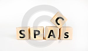 SPACs, special purpose acquisition companies symbol. Cubes with words `SPACs, special purpose acquisition companies` on beautifu photo