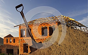 Spade,sand and house