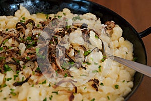 Spaetzle with melted cheese in pan - kÃ¤sespÃ¤tzle kasnocken