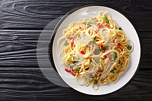 Spaghetti aglio e olio Italian for spaghetti with garlic and oil is a traditional pasta dish from Naples close-up in a plate.