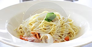 Spaghetti aglio olio with seafood in white plate