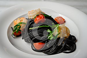 Spaghetti al Nero di Seppia with Squid Ink and Prawns photo