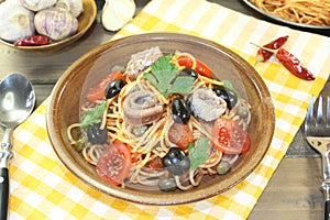 Spaghetti alla puttanesca with olives, capers and anchovies
