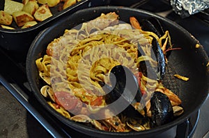 Spaghetti allo scoglio or spaghetti with seafood served i with shrimps and other shells