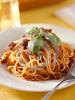 Spaghetti with basil garnish in meat sauce